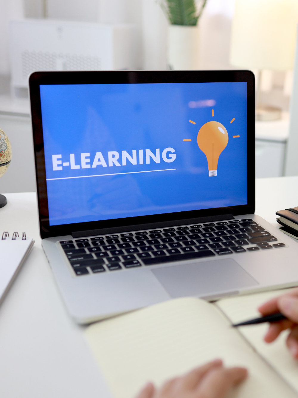 Young businesswoman sitting and used laptop with inscription on screen e-learning. Online education e-learning.